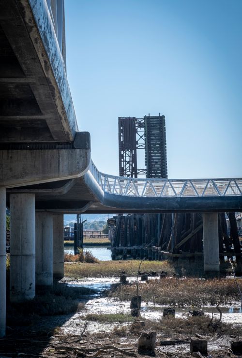 Free View of an industrial bridge structure in a city with exposed concrete and metal elements. Stock Photo