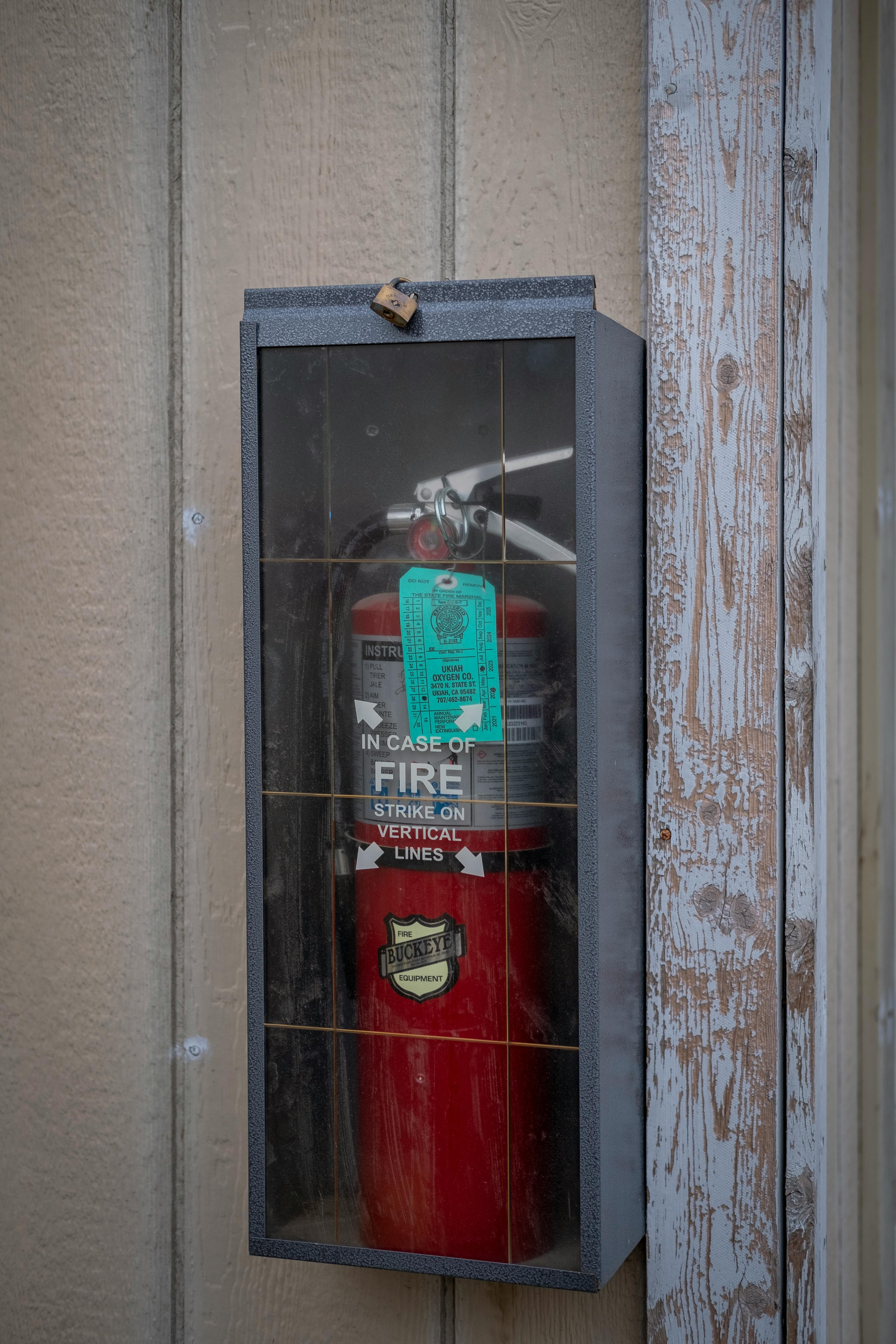 fire extinguisher in box on wall