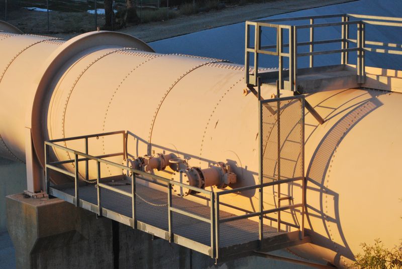 Industrial pipeline with metal platform and ladder