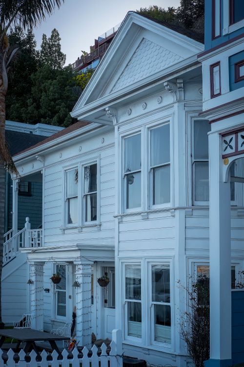 Free Charming white Victorian-style house with classic architectural details. Stock Photo