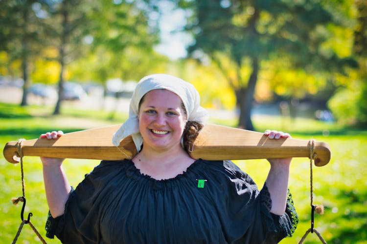 Smiling Woman Carrying Wooden Yoke