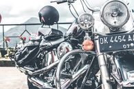 Black and Gray Cruiser Motorcycle Parked Near Railings