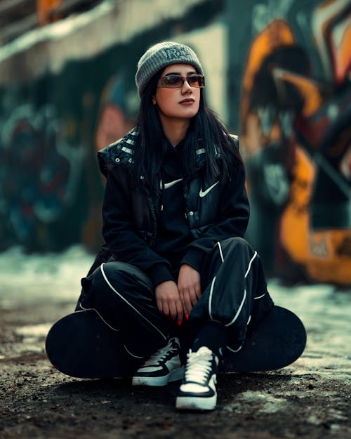 Portrait of a Female Model Wearing Street Clothes Sitting Outdoors