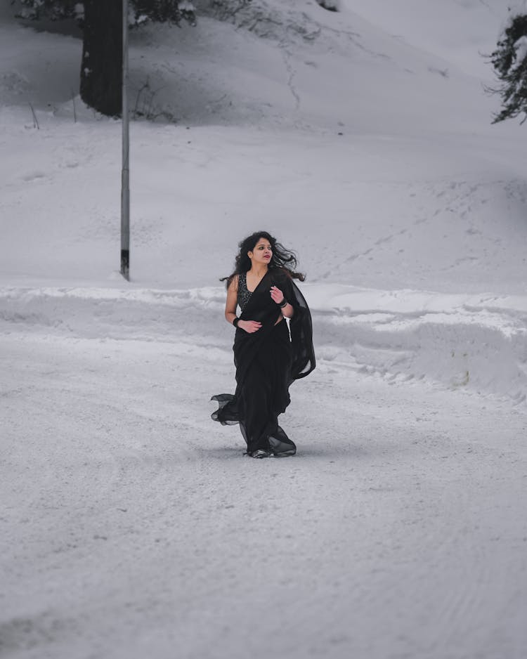 Woman Wearing Black Sari Among Snow 