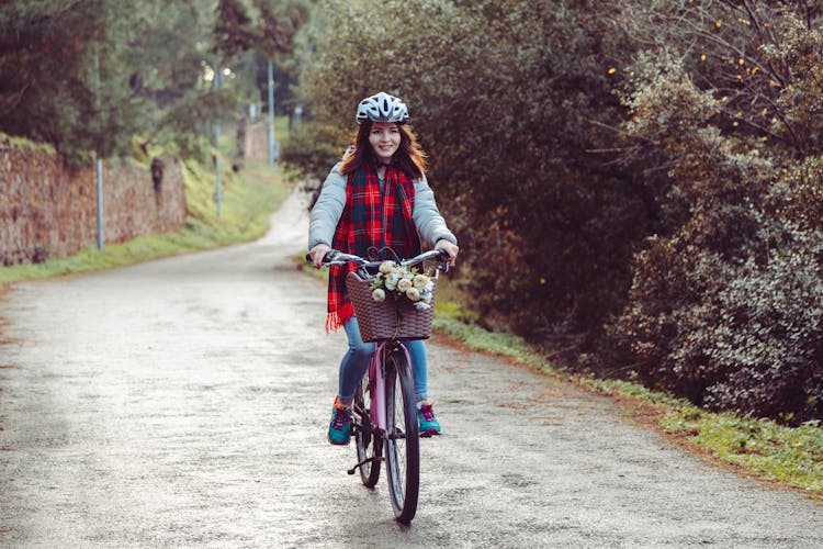 Woman Riding A Bicycle On The Street