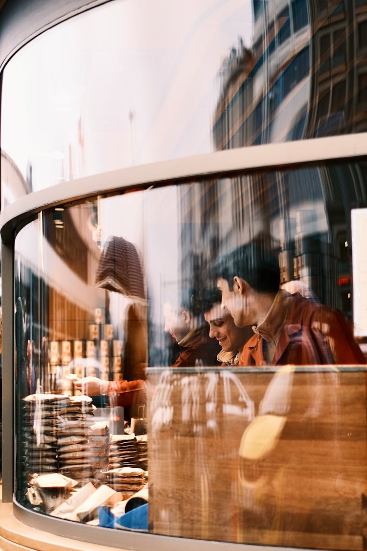 Closeup Of Man Working In A Bar, And Reflection In The Window