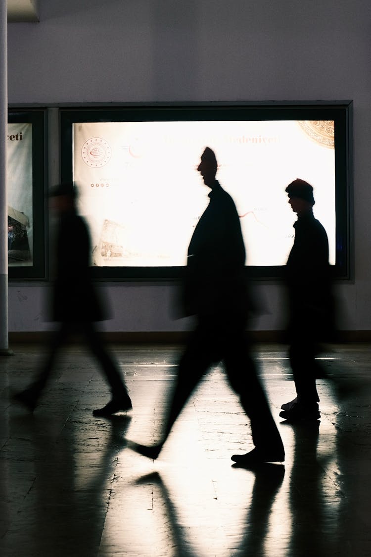 Blurred Silhouettes Of People Walking On A Station