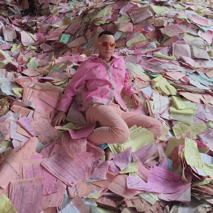 Man Wearing Pink Clothing On Colorful Pastel Documents