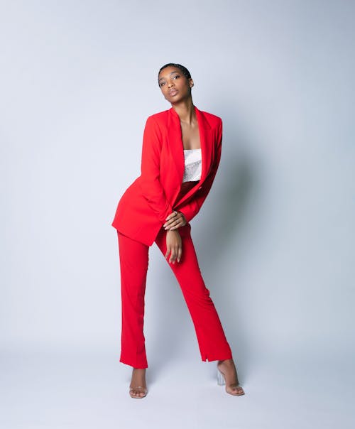 A Woman in Red Blazer and Pants Posing