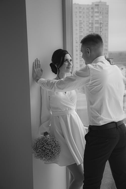 Elegant Couple Flirting by Window