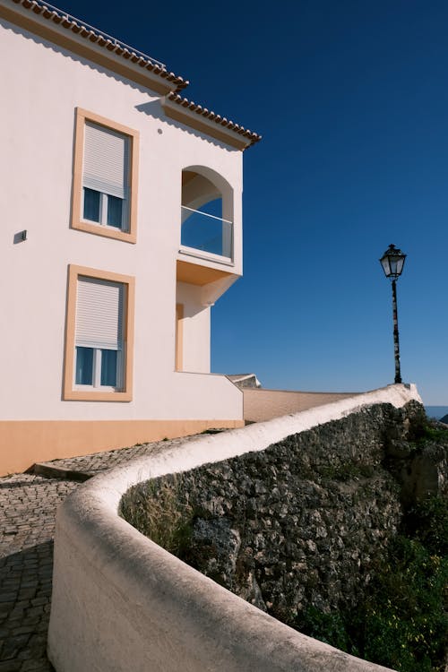 Clear Sky over Sunlit House Wall