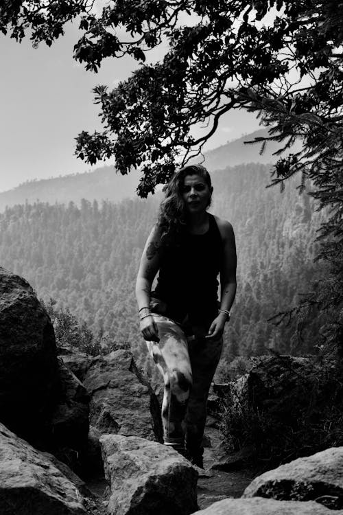 Woman Posing on Rocks in Forest