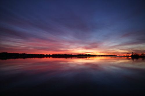 Free Serene sunset at Stamford lake with colorful sky reflections, capturing peaceful nature. Stock Photo