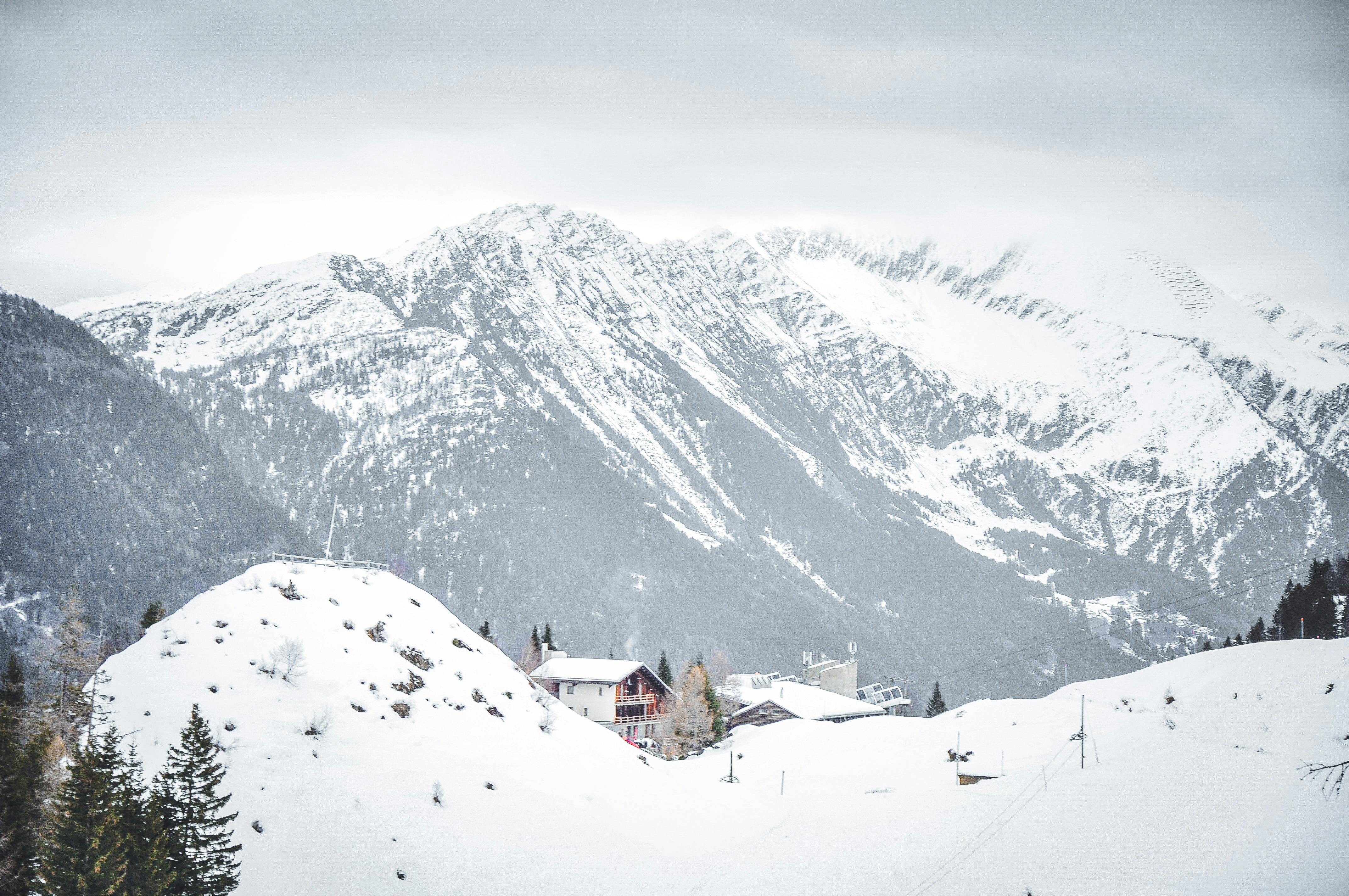 Prescription Goggle Inserts - A picturesque snowy village nestled in the mountains under overcast skies.