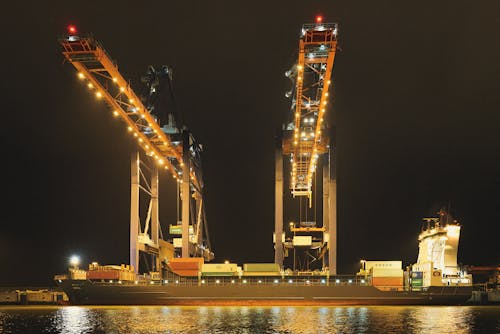 Illuminated Cranes over Container Ship