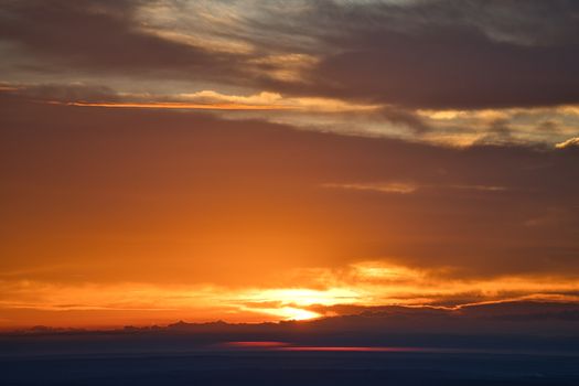 Beautiful sunrise over Stone Mountain, GA, showcasing warm hues and cloud formations.