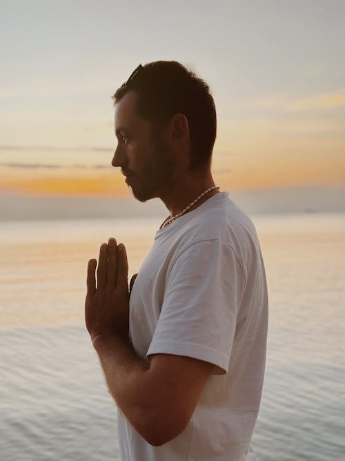 Man Meditating on Sea Shore