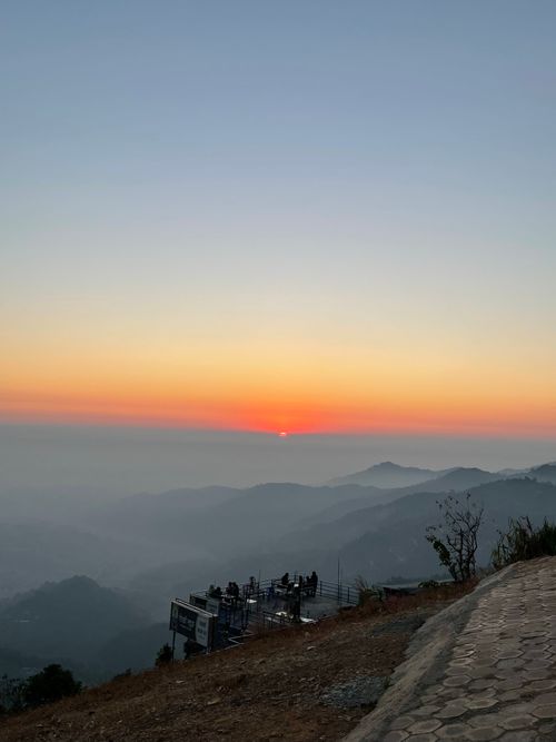 Free Capture the serene beauty of a sunrise over misty mountains with a tranquil view deck. Stock Photo