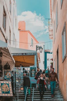 游客们探索欧洲风景如画的小巷，巷子两旁排列着商店和充满活力的建筑