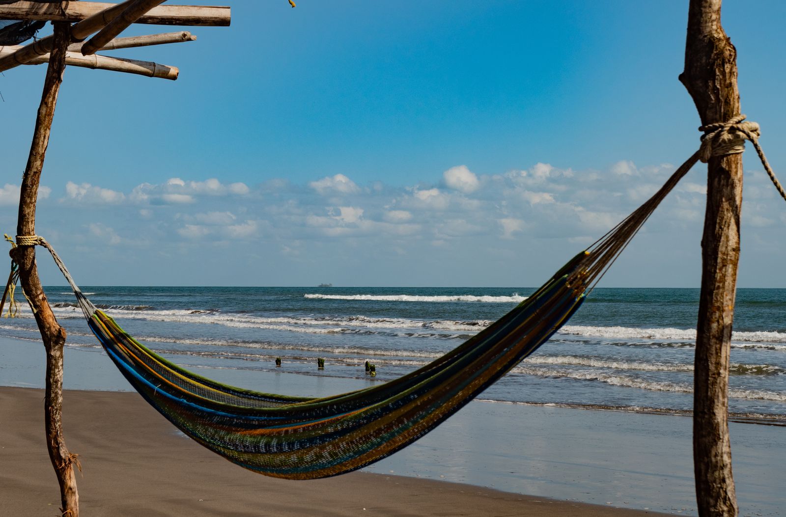 Hammock hanging beside a quiet beach