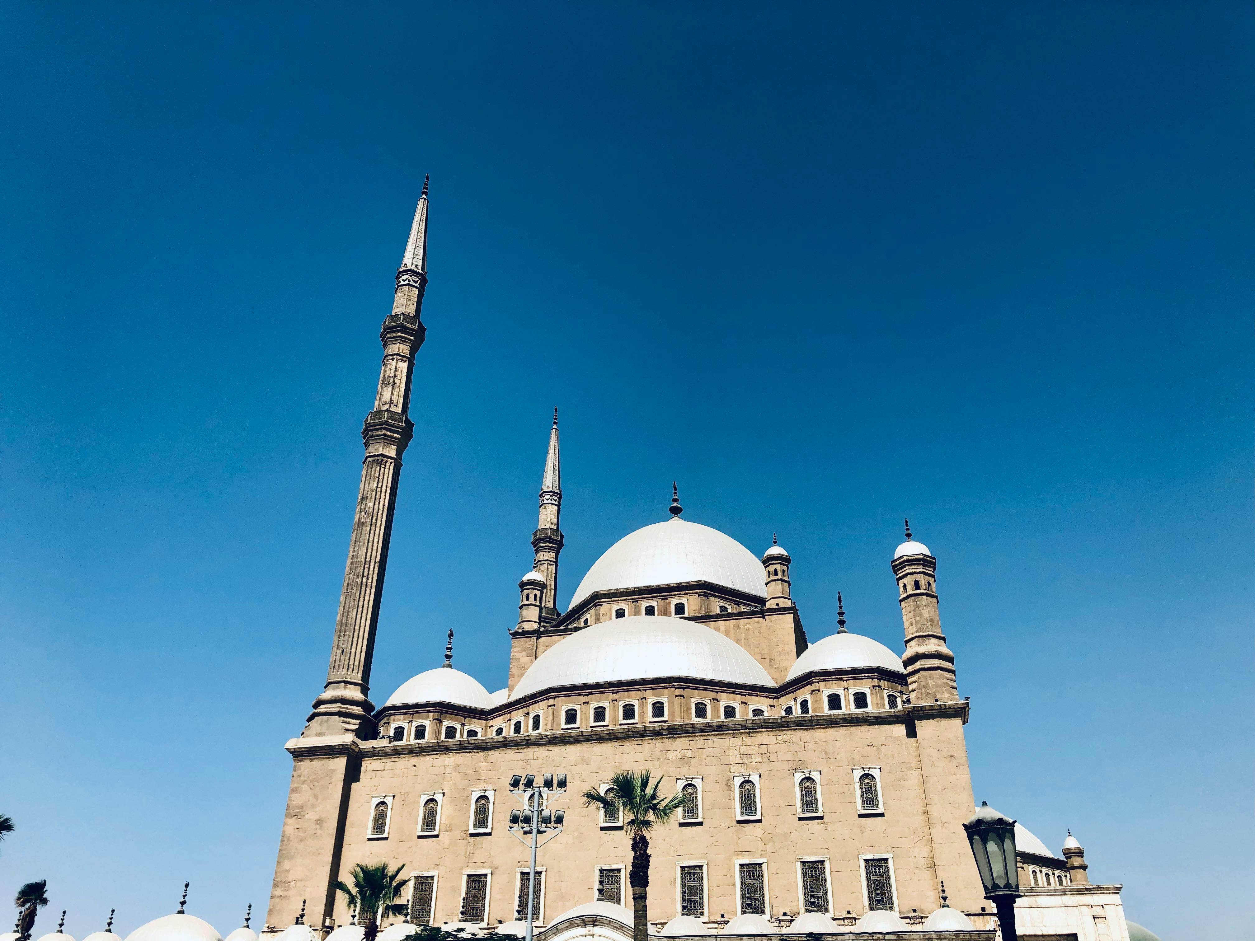 Beautiful capture of the Mosque of Muhammad Ali under a clear blue sky in Cairo, Egypt.