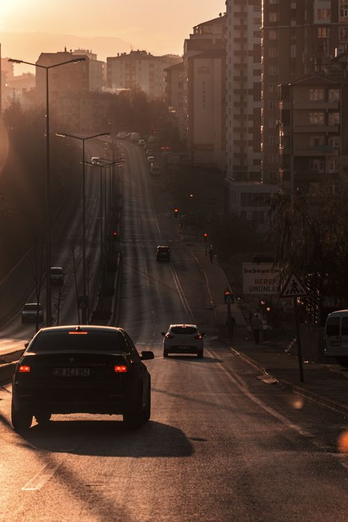 Free Cars on a city street in Kayseri, Turkey at sunset, featuring urban buildings and warm lighting. Stock Photo