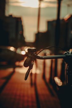 Silhouette of a bicycle against a Warsaw sunset, showcasing city life.