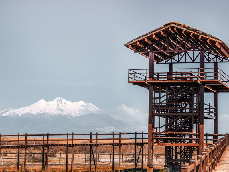 A wooden observation tower on a mountain ridge