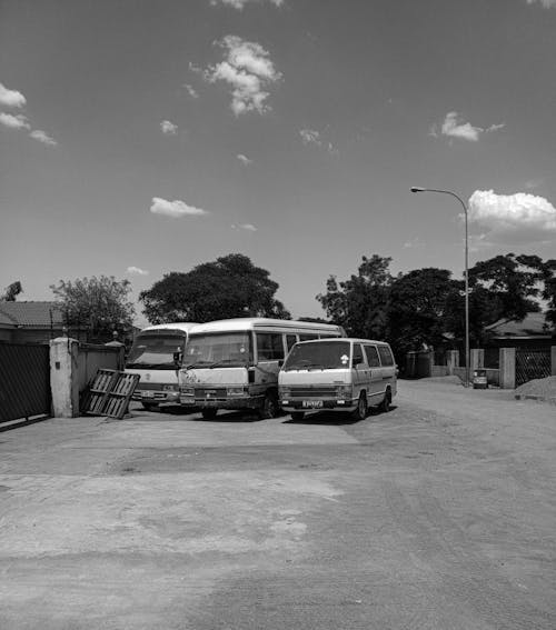 Grayscale Photo of Vehicles on the Road