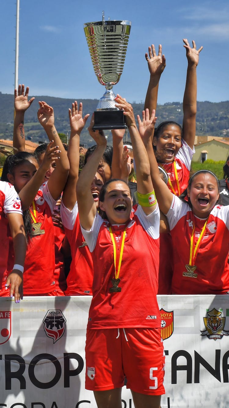 Football Team Celebrating With Trophy