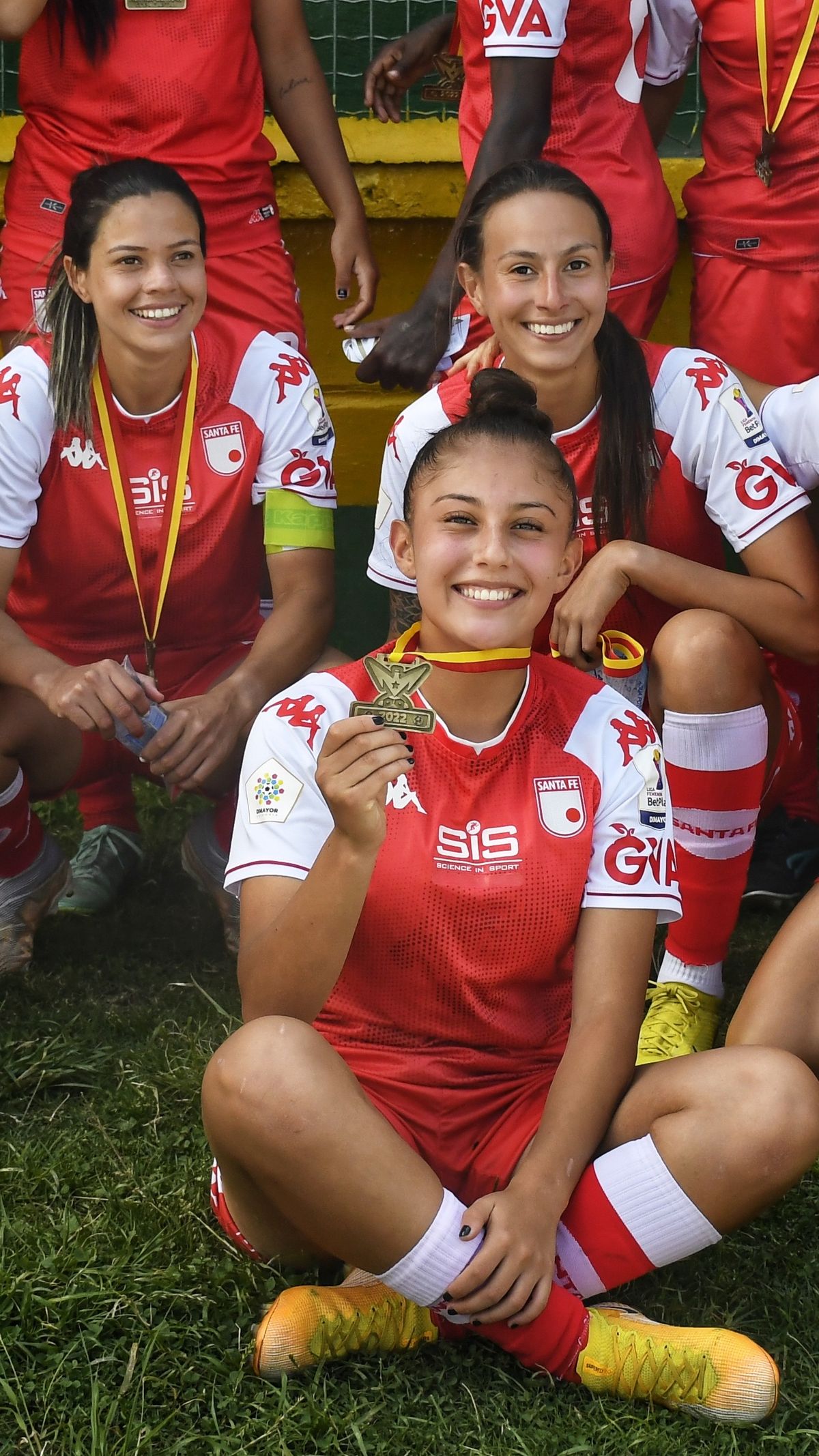 Players celebrating with medals after a cup victory