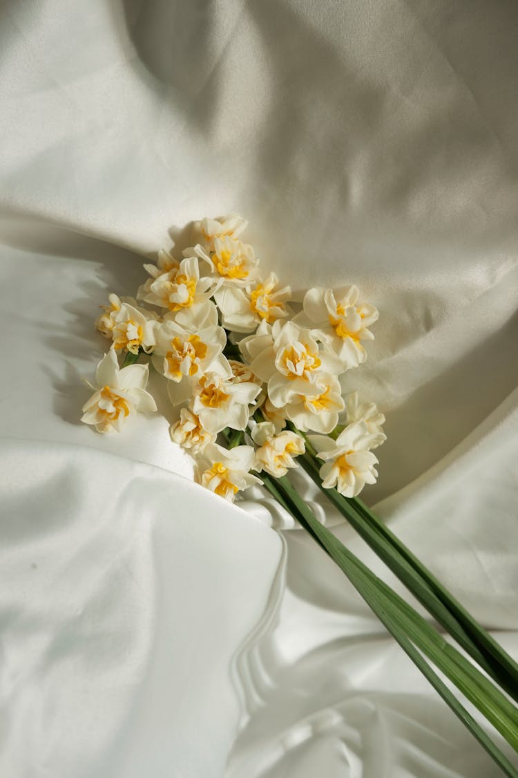 Bunch Of Flowers Lying On A White Fabric