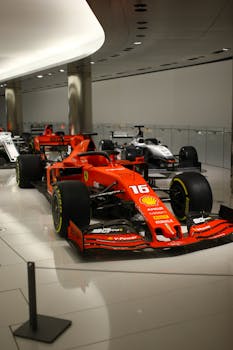 Ferrari Formula 1 race cars exhibited in an indoor showroom.