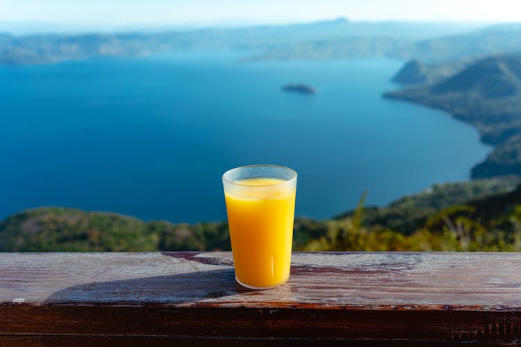 Glass Of Orange Juice On Handrail