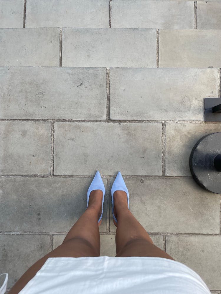 First Person View Of Woman Wearing A Skirt And High Heels 