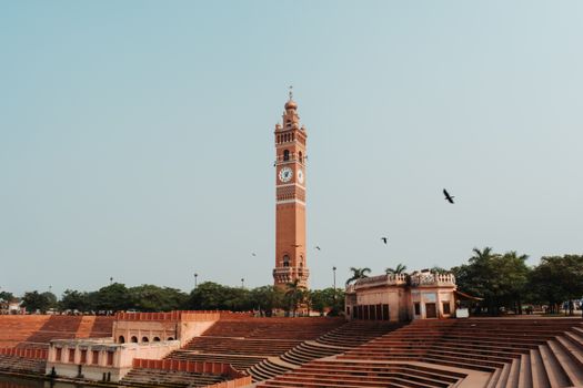 A clock tower in the middle of a large red brick building