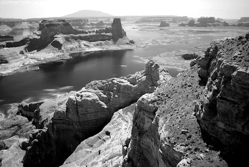 Grey Concrete Rock Beside Body of Water