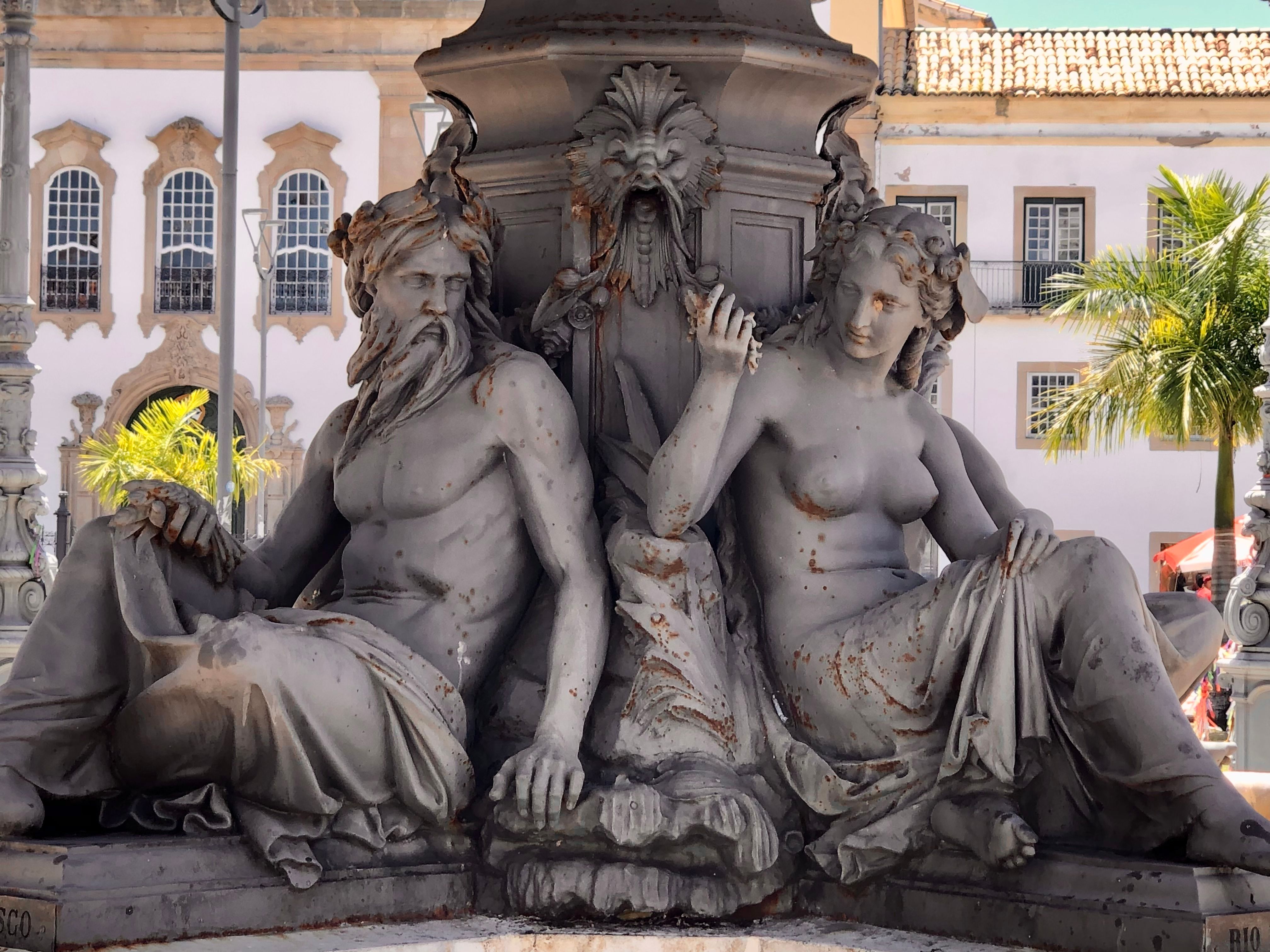 Detailed view of historic sculptures from a fountain in Salvador, capturing expressive artistry and urban charm.