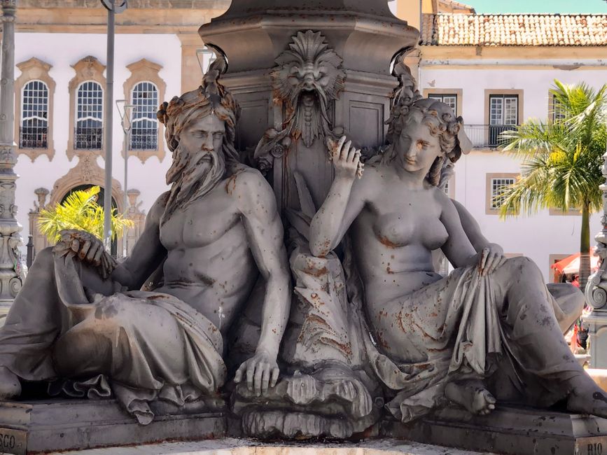 Detailed view of historic sculptures from a fountain in Salvador, capturing expressive artistry and urban charm.