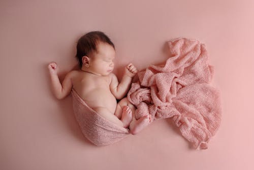 A Newborn Baby While Sleeping 