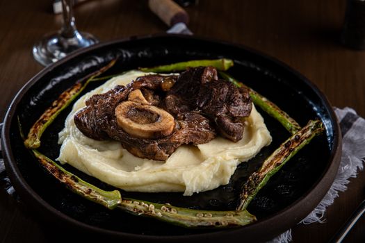 Deliciously cooked beef steak served with creamy mashed potatoes and grilled asparagus.