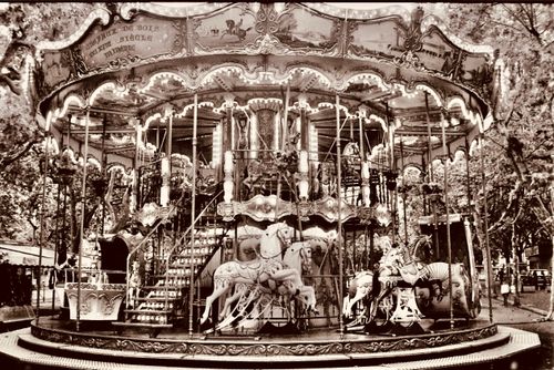 Free Charming vintage carousel ride in a French park, capturing nostalgic amusement. Stock Photo