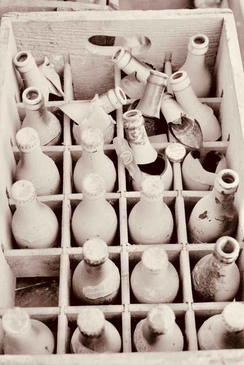 Free Old dusty glass bottles in a wooden crate, illustrating a vintage feel. Stock Photo