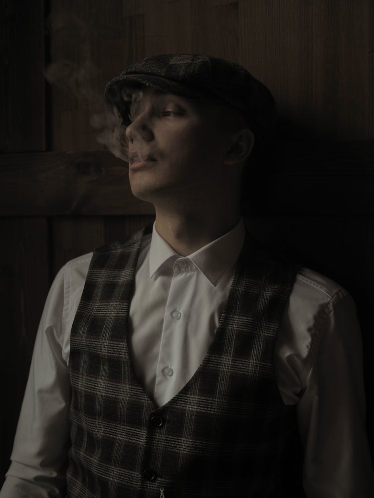 Young Man In A Suit Smoking A Cigarette 