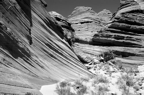 Grey Scale Photography of Rocky Mountain Grass Fields