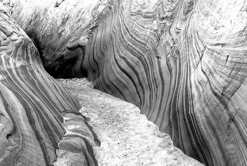 Free Stunning black and white photo of swirling sandstone formations in a desert landscape. Stock Photo