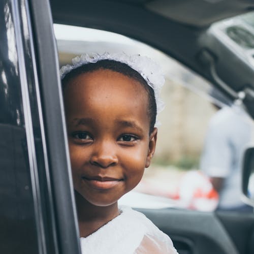 Smiling Girl Wearing White Top Inside Car