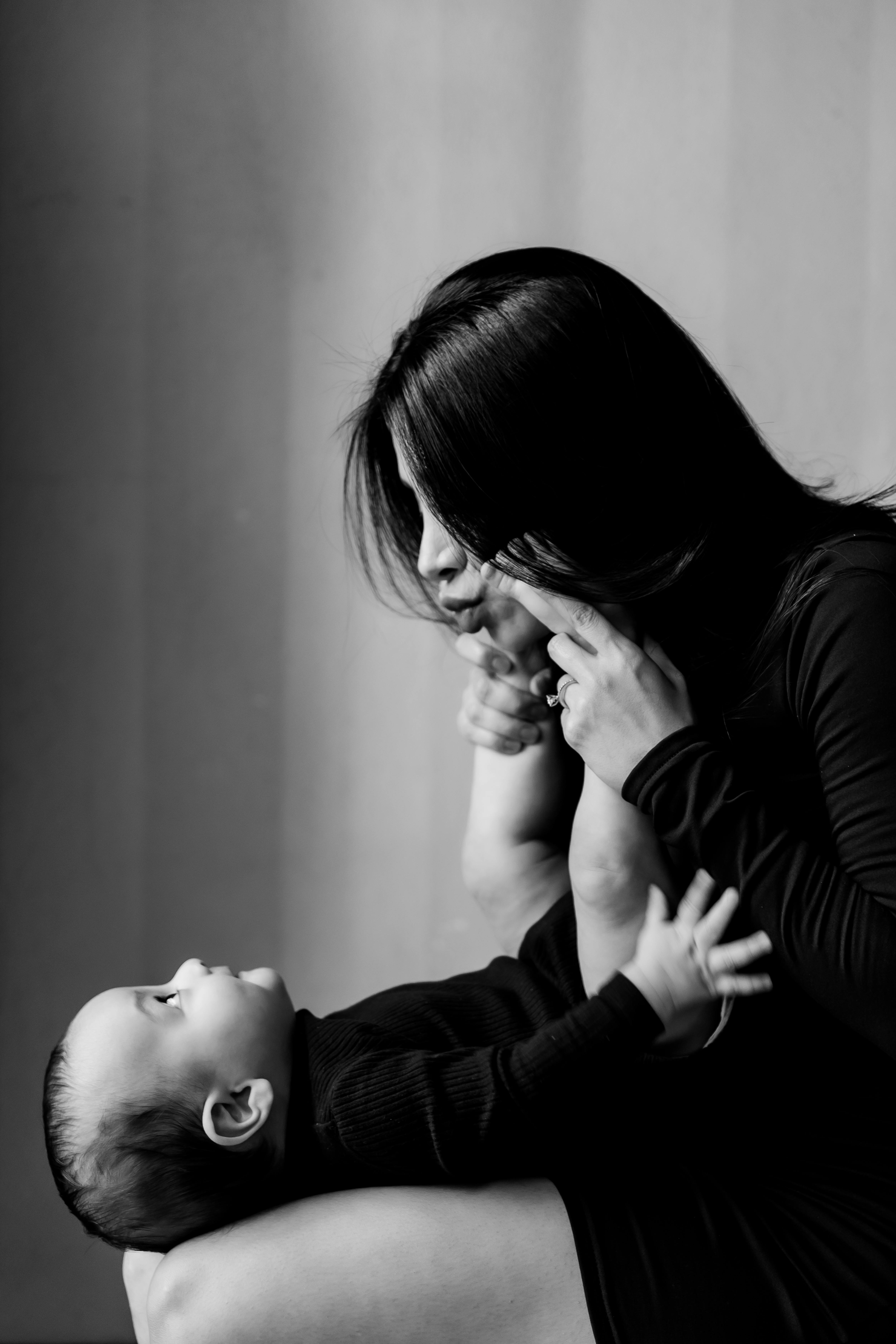 mother holding a newborn baby on her knees