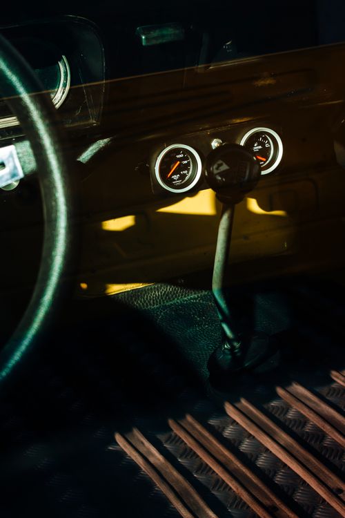 Free A detailed view of a classic car's interior highlighting the vintage gear shifter and dashboard dials. Stock Photo