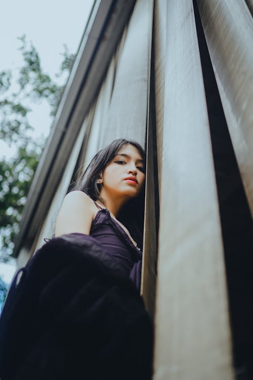 Young Woman Leaning on a Wall